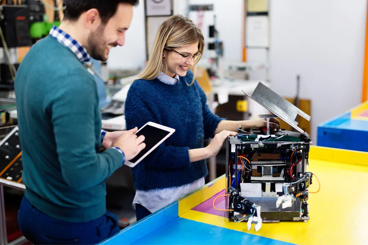 Engineers working together on a robot